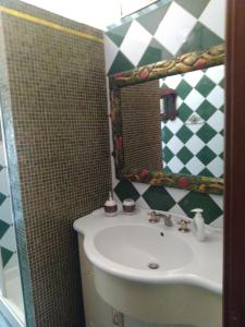 a bathroom with a sink and a mirror at la casa di Aldo in Perugia