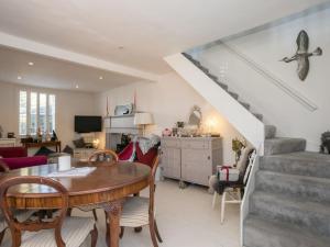 uma sala de estar com uma mesa e uma escada em Gorgeous House near Windsor & River Thames em Datchet