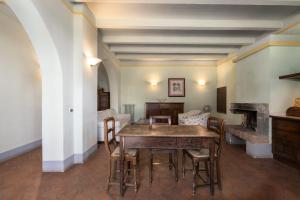 a dining room with a wooden table and chairs at Fattoria la Gigliola - Il Frantoio in Montespertoli