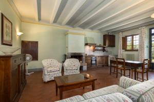 a living room with a couch and a table at Fattoria la Gigliola - Il Frantoio in Montespertoli