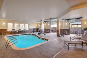 a pool in a hotel lobby with chairs and tables at Fairfield Inn & Suites by Marriott Yakima in Yakima