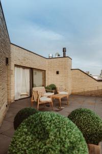 a patio with two chairs and a table on a building at CH Longstay 2 in Kortrijk