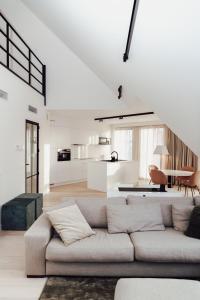 a white living room with a couch and a table at CH Longstay 2 in Kortrijk