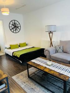 a living room with a bed and a couch and a table at East Central London -Studio in London