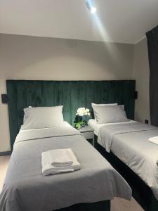 a bedroom with two beds with towels on them at Kali Apartments in Bitola