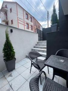 a patio with two tables and chairs and stairs at Kali Apartments in Bitola