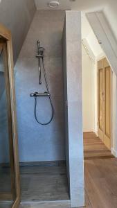a bathroom with a shower in the corner of a room at Het Heertje in Den Hoorn