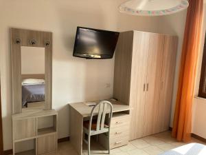 een kleine slaapkamer met een bureau en een spiegel bij Appartamenti Aspromonte in Milaan