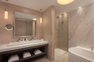 a bathroom with a sink and a shower at The Westin Dragonara Resort, Malta in St. Julianʼs