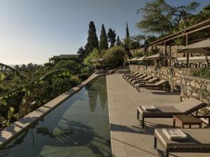 a swimming pool with lounge chairs and a resort at Kinsterna Hotel in Monemvasia