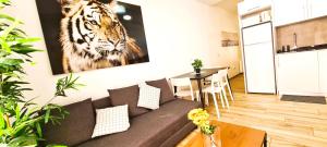 a living room with a tiger picture on the wall at Oshun Plaza Castilla in Madrid