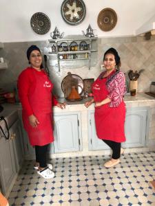 two women are standing in a kitchen at Riad le Consulat - Riad privé avec services in Essaouira