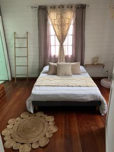 a bedroom with a large bed and a window at Le Calbanon cilaos in Cilaos