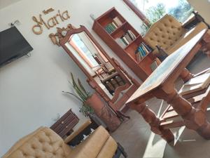 sala de estar con 2 sillas y mesa en Hotel Maria Cafayate en San Carlos