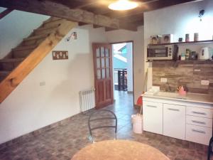 a kitchen with a table and a counter top at Chaltén Apart 365 in El Chalten