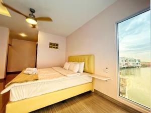 a bedroom with a bed and a large window at Billiards And Karaoke, Free Pickup in Sengkuang