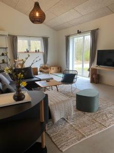 a living room with a couch and a table at Country Home in Hejnsvig