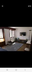 a large living room with a table and a couch at Apartamento El Muro in Laredo