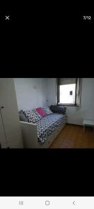 a bedroom with a bed in a room with a window at Apartamento El Muro in Laredo