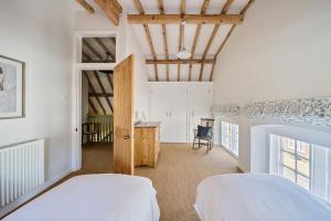 a bedroom with two beds and a desk in a room at The Old Court House in Cerne Abbas