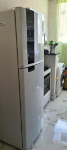 a white refrigerator sitting in a kitchen at Apartamento in Capitólio