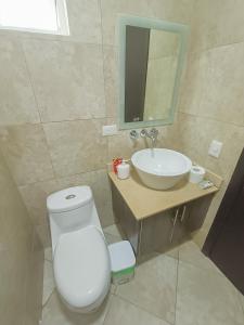 a bathroom with a white toilet and a sink at Panoramic 2 View to the ocean Manta in Manta