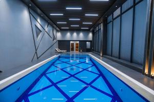 a swimming pool in a building with a ceiling at PREMIER HOTEL in Andijan
