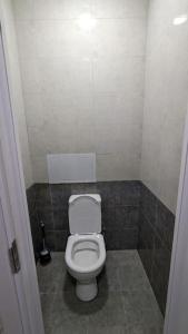 a bathroom with a white toilet in a room at Квартира в новом жилом комплексе Invest House in Tashkent