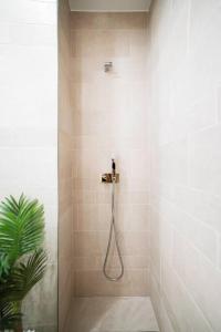 a shower with a hose in a bathroom at SUPER Central - Cork in Funchal