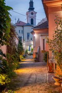 a street in a town with a clock tower at Apartman Centar in Sremski Karlovci
