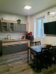 a kitchen with a table and chairs and a television at Apartment in central Bucharest in Bucharest
