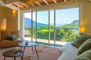 a living room with a couch and a large window at La Villa Jausserane in Toulon