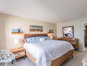 a bedroom with a bed and a table and a mirror at La Puerta Beautiful Bayfront Condo in St Petersburg +18 photos