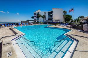 a swimming pool with blue water in a resort at La Puerta Beautiful Bayfront Condo in St Petersburg