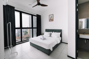 a bedroom with a bed and a large window at NEW Infinity Pool 3 Bedrooms 2 Carparks in Jelutong