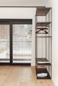 a black shelf in a room with a window at CH Longstay 33 in Kortrijk