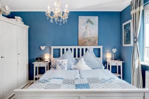 a blue bedroom with a bed with blue walls at Bluehome Ferienwohnung in Bad Bellingen