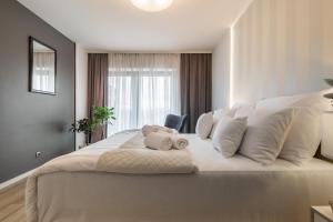 a bedroom with a large bed with white pillows at Apartment 24 Premium Old Town Wroclaw in Wrocław