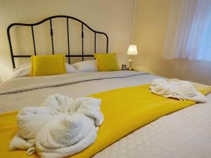 a bed with white towels on top of it at Villa Sabina in Fužine