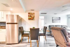 a kitchen and dining room with a stainless steel refrigerator at 3 Mi to Beach Remodeled Seminole Apt with Yard! in Redington Shores +17 photos