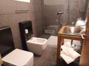 a bathroom with a sink and a toilet at Allod Bad 504 in St. Moritz