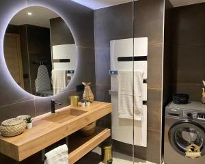 a bathroom with a sink and a washing machine at Le Galatée Porticcio in Porticcio +39 photos