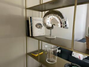 a shelf with a fan and a book on it at La cerise sur le gâteau in Volmunster