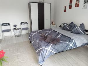 a bedroom with a bed and two chairs at Vila ANA in Cluj-Napoca