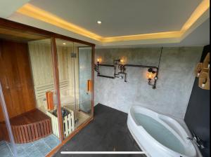 a bathroom with a tub and a sink and a shower at Balitri - designer villa with shala pool spa in Sukawati