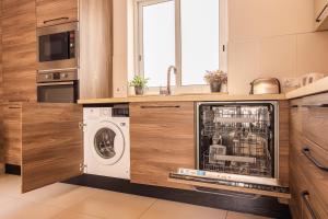 a kitchen with a washer and dryer in a kitchen at Balluta Bay Spacious APT - 2BR in Sliema