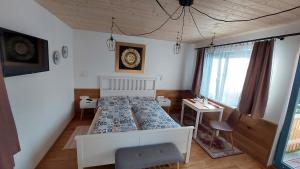 a bedroom with a bed and a table and a window at Pavlov24 - Domeček u potoka in Pavlov