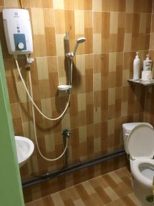 a bathroom with a shower with a toilet and a sink at Can Tho Riverside Hostel in Bình Thủy