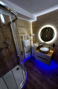 a bathroom with a sink and a shower with a mirror at WX Hotel in Bratislava +46 photos