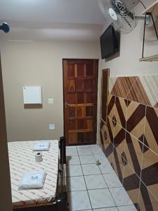 a room with a bed and a door at Hotel coruja's, Santo amaro ,São Paulo-SP in São Paulo